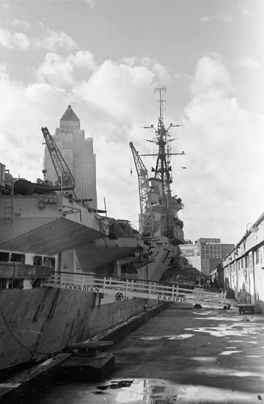 The Marine Building 6 The Marine Building looking over the British aircraft carrier HMS Glory in 1945. Photo by James Crookall, City of Vancouver Archives #260-1537.