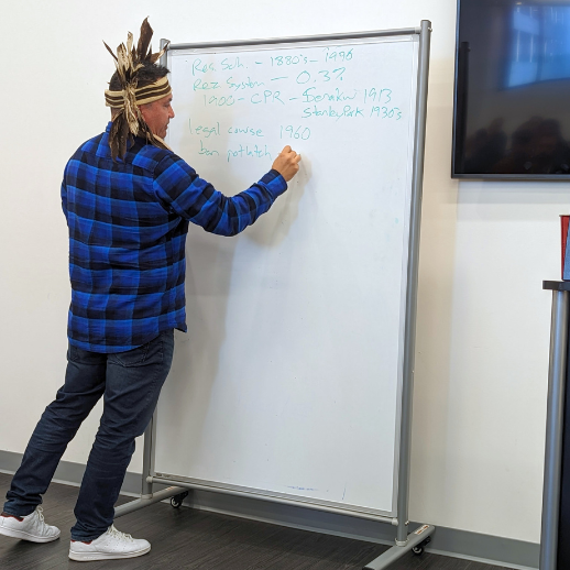Chief Ian Campbell writes on a whiteboard during