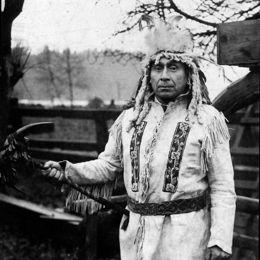 Joe Capilano poses for a photo in full headress