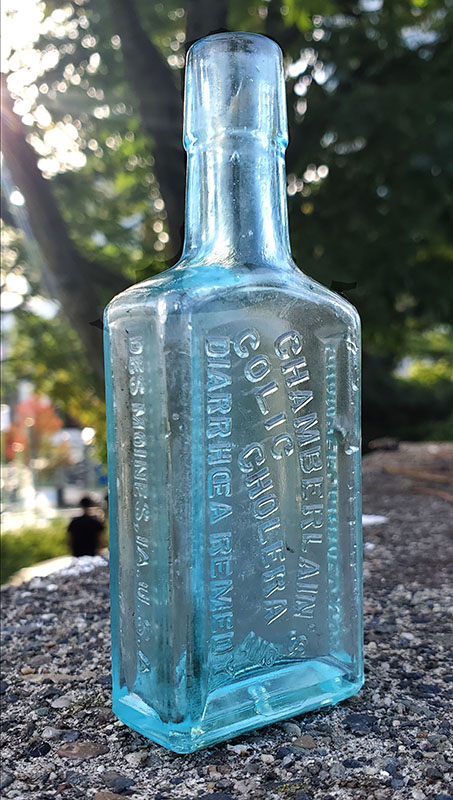 Vintage advertisement for Chamberlain's Colic Remedy, showcasing the product's benefits and branding. Chamberlain's Colic, Cholera, and Diarrhoea Remedy bottle.