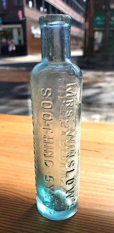 Advertisement for Mrs. Winslow's Soothing Syrup, highlighting its use for calming babies. Mrs Winslow's Soothing Syrup bottle, the best known of the "baby killer" patent medicines because of its morphine and alcohol content.